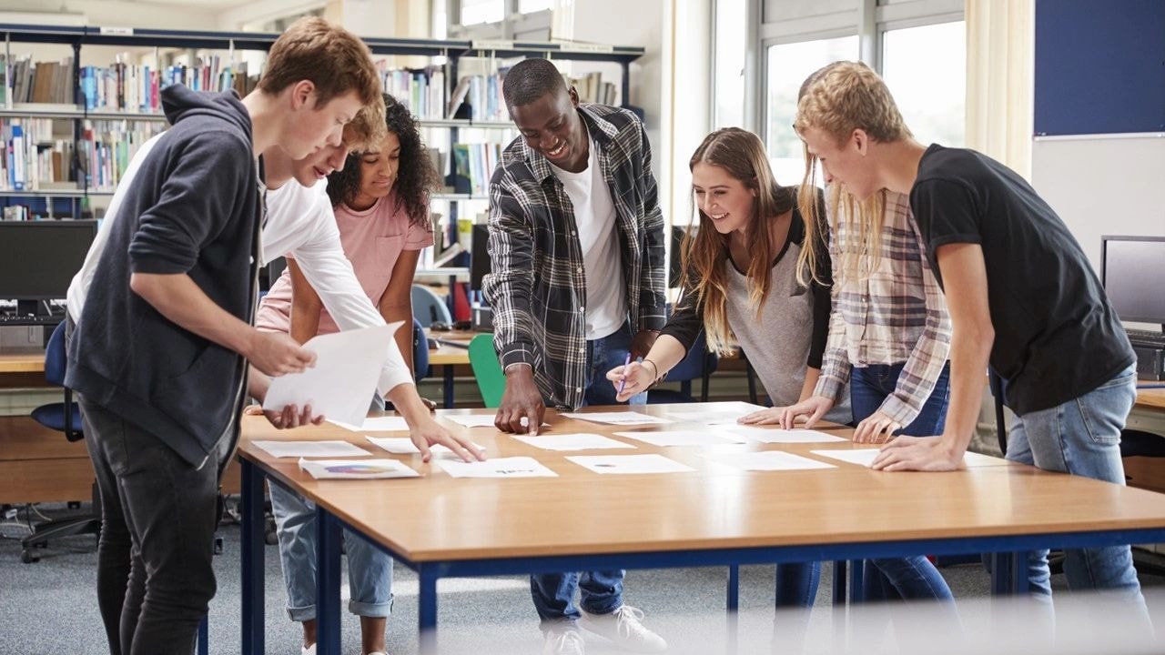 Educators collaborating around a table in a modern school setting